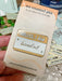 Name-tag enamel pin reading HELLO, I AM burned out, with a warm yellow header, pale background, and star accents.