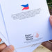 Back of a Paper Picture Mama Filipino Collection card describing its community giving program.